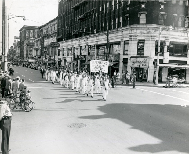 Carpenters Union Local 18 marching up James Street on September 2, 1958. They are just passing the Lister Building at the corner of King William Street. Carpenters Union Local 18 marching up James Street on September 2, 1958. They are just passing the Lister Building at the corner of King William Street.