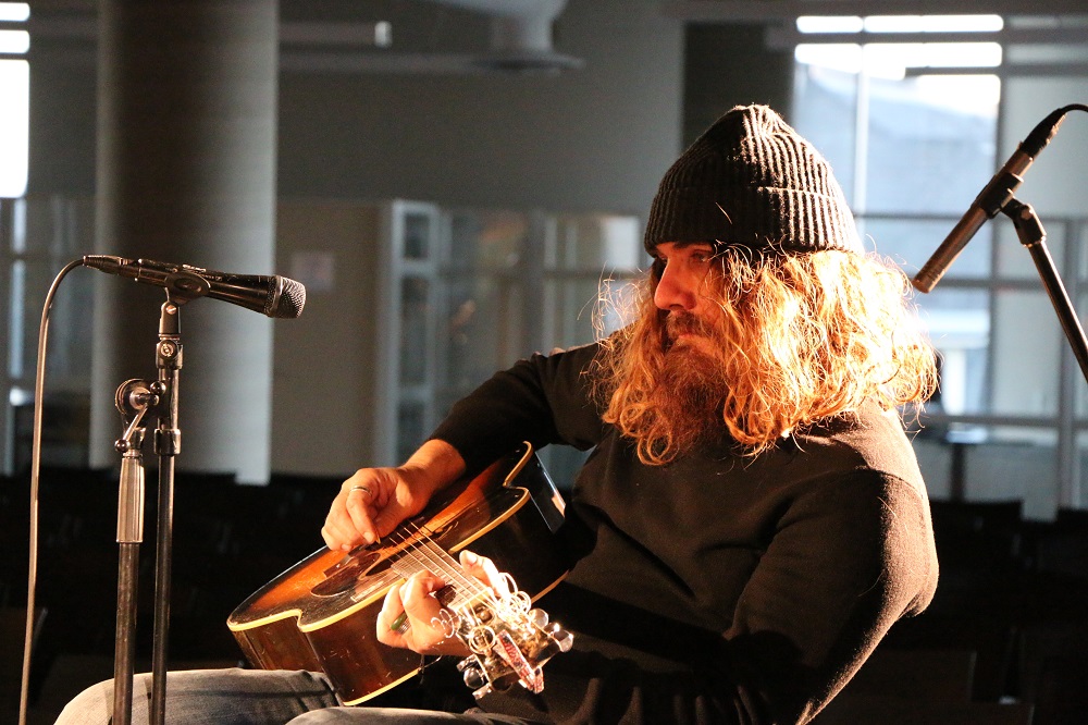 Photo of Tom Wilson doing a sound check before the Blackie and the Rodeo Kings concert