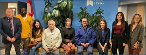 The Library board with the CEO sitting in front of a small garden in front of a blue HPL wall.