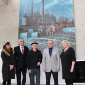 a group of people standing in front of a painting