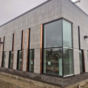 Outside of the new Valley Park branch the corner is shown with a large glass wraparound window