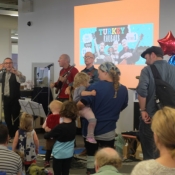 3 males performing to a crowd